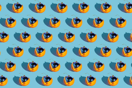 Creative pattern layout made with disco ball ornament inside of orange on blue background. Minimal party or festive concept. Flat lay.の写真素材