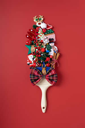 Creative Top view flat lay Christmas concept composition. Paint brush made of snowman, ornaments and Santa with copy space. Square Template mock up fall new year wedding anniversary invitation card.の写真素材