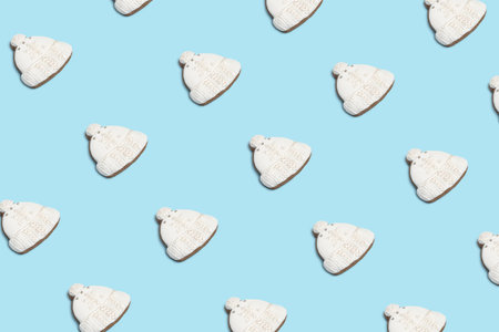 Creative minimal Christmas art. Pattern made with Christmas cookies on bright blue background. Flat...