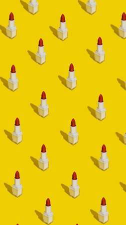 Make up pattern made with red lipstick on yellow background. Minimal beauty salon concept with trendy summer shadows. Flat lay, top view.の写真素材