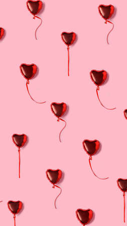 Love layout made with flying heart shaped balloons on pastel pink background. Minimal Valentines...