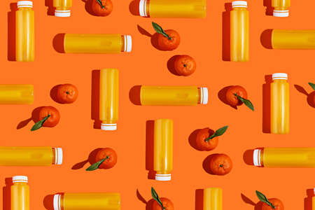 Fresh orange citrus with leaf and shadows forming geometrical square shape on pastel orange...