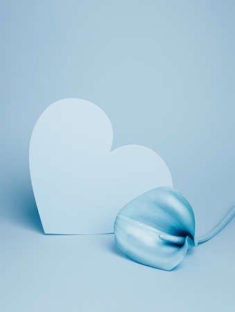 Heart and calla lily flower on pastel blue background. Concept scene stage showcase, for product, promotion, sale, banner, presentation. Minimal cosmetic or fashion floral showcase mock up concept.の写真素材