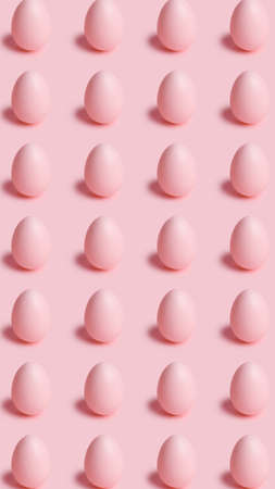 Easter pattern made with pink eggs on bright pastel background. Minimal Easter or food concept. Flat lay, top view.の写真素材