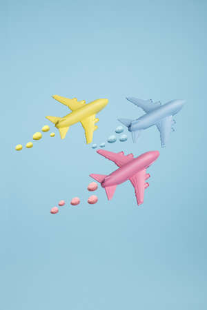 Jet airplanes leaving egg trails against sky blue background. Minimal art Easter concept....