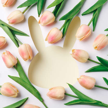 Easter border template with bunny head shape background. Minimal Easter holiday greeting card or banner with frame for copy space. Flat lay, top view.の写真素材