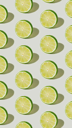Texture made with slices of lime isolated on a bright white background. A pattern of citrus fruit...