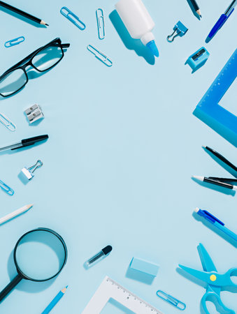 School supplies on blue background. Back to school concept. Flat lay, top view.