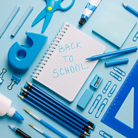 Back to school concept. School supplies on blue background. Top viewの写真素材