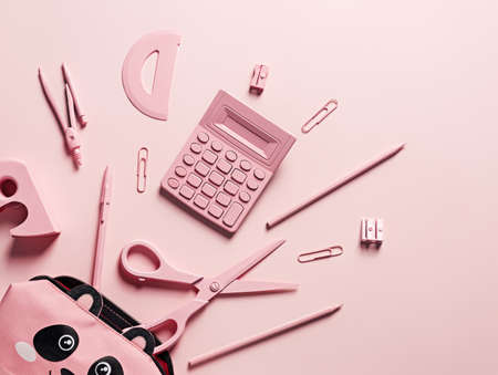 Office and school equipment in pastel pink color. Calculator, scissors, pens, pencils, staples,...