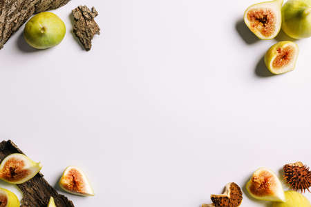 Frame made with with autumn fruits and leaves on bright white background. Creative fall season...
