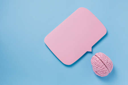 Brain and speech bubble on blue background. Brainstorming and communication conceptの写真素材