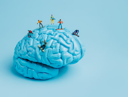 Miniature snowboarders on blue painted human brain on pastel blue background. Creative winter sports concept. Extreme sports state of mind.の写真素材