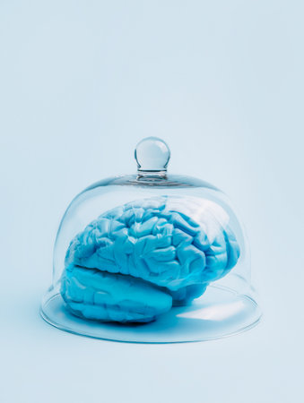 Blue human brain under the glass dome on bright background. Creative censorship or unified opinion concept. Minimal brainwashing or state of mind layout. Abstract art composition.の写真素材