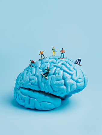 Human brain with miniature people on blue background. Mental health and medical conceptの写真素材