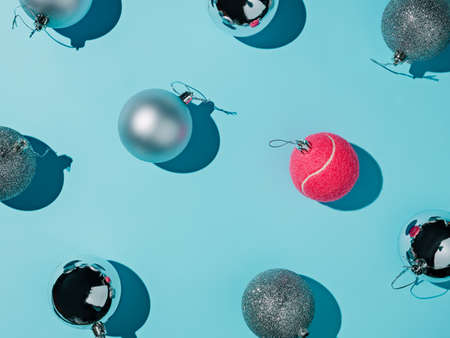 Creative layout made of Christmas baubles on blue background. Minimal New Year concept.の写真素材