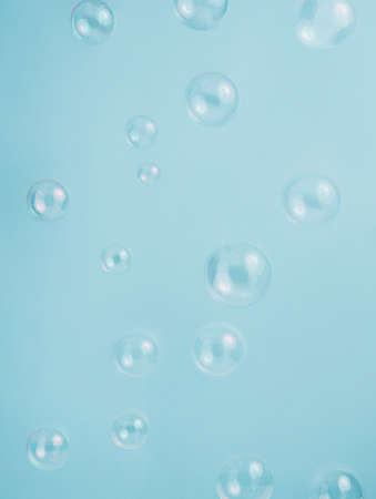 Soap bubbles on light blue background, flat lay. Space for textの写真素材
