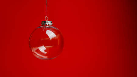 Christmas ball hanging on a red background with copy space. Christmas and New Year concept.の写真素材