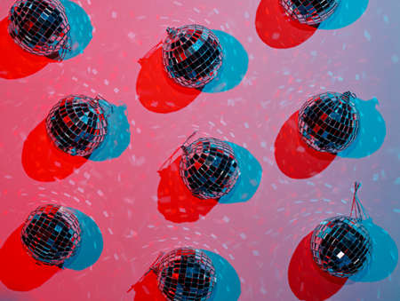 Disco ball on a pink background with splashes of water.