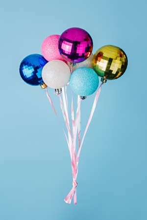 Multicolored balls with ribbons on a blue background.の写真素材