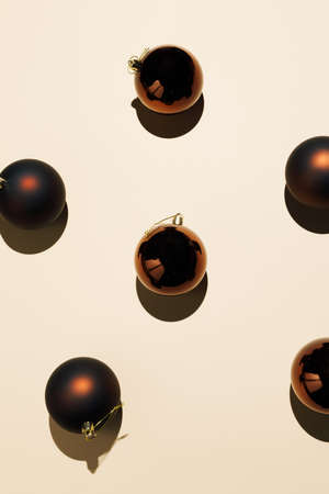 Creative Christmas pattern made of black baubles on pastel beige background. Minimal holiday concept.の写真素材