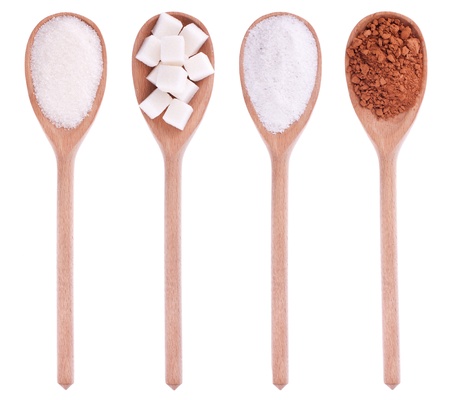 Wooden spoons with sugar, lump sugar, salt, cocoa, isolation on a white backgroundの写真素材