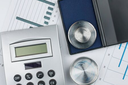 Calculator and print on a background of diagrams