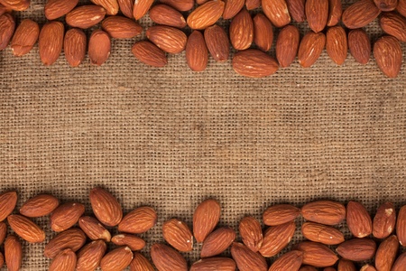 Almond lying on burlap can be used as backgroundの写真素材