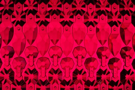 Glass elements are laid out on a red  backgroundの写真素材