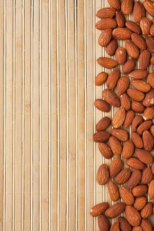 peeled almonds lying on a bamboo mat can be used as backgroundの写真素材