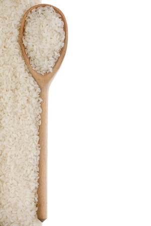Rice in a wooden spoon isolated on a white backgroundの写真素材