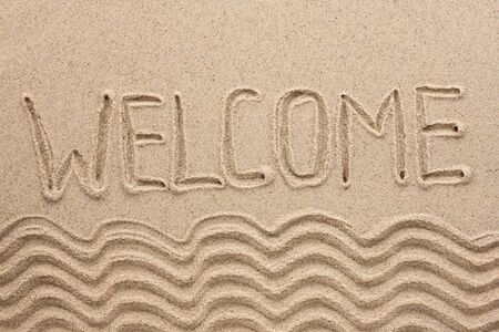 Word welcome written on the sand as the backgroundの写真素材