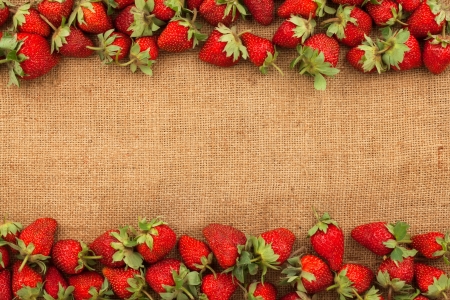 Strawberries lying on sackcloth as backgroundの写真素材