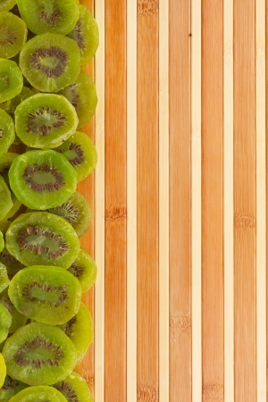 Dried kiwi lying on a bamboo mat as backgroundの写真素材