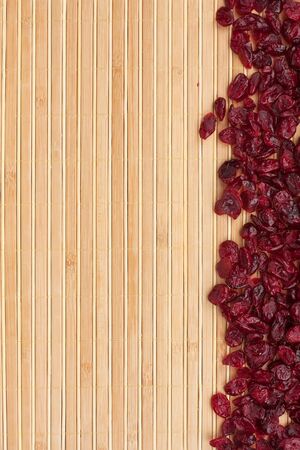 Dried cranberry  lying on a bamboo mat, as backgroundの写真素材