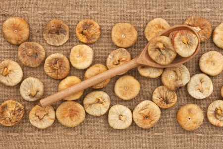 Wooden spoon with  figs , lying on sackclothの写真素材