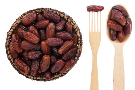 Spoon, a fork, a plate with dried date, isolated on white backgroundの写真素材