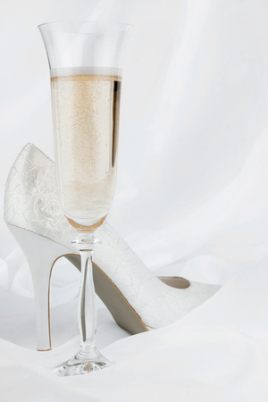 Wedding  glass  and shoes on a white backgroundの写真素材