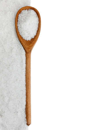 wooden spoon with salt , isolated on white backgroundの写真素材
