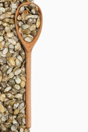 wooden spoon with pumpkin seeds,Isolated on white background
