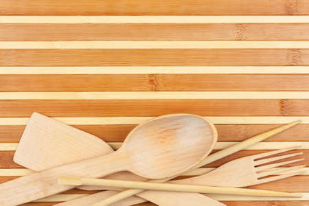 Spoon, fork, chopsticks, paddle, on a bamboo mat の写真素材