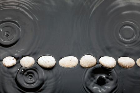 White stones in the water in the rain, can use as background