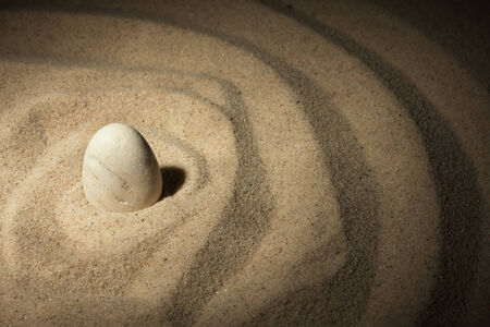 White stone sticking out of the sand can be usedの写真素材