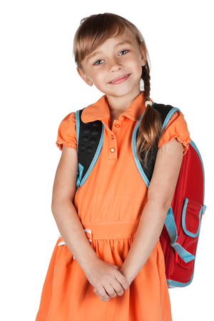 Cute schoolgirl with a red backpack on her shoulders, isolated on white backgroundの写真素材