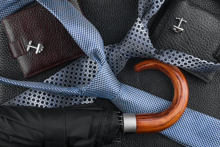  Wallet, tie, cufflinks, umbrella lying on the skin, can be used as backgroundの写真素材