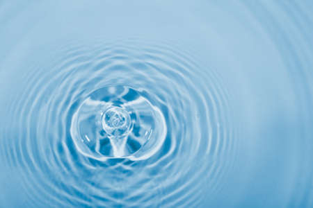 Drop of water falling into the water, can be used as background