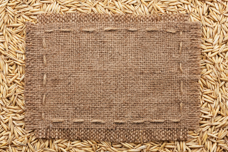 Frame of burlap  lying on a oats  background, with place for your textの写真素材