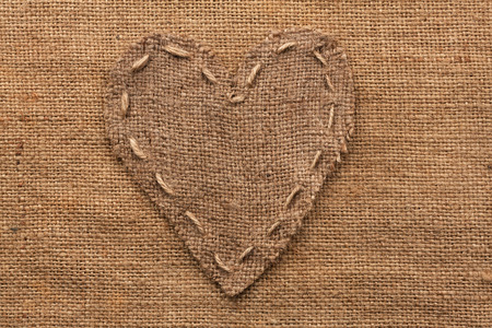 Heart  of  burlap, lies on a background of burlap, with place for your text