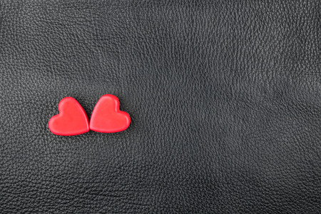 The concept of two lovers hearts lying on the natural leather, can be used as a background, textureの写真素材