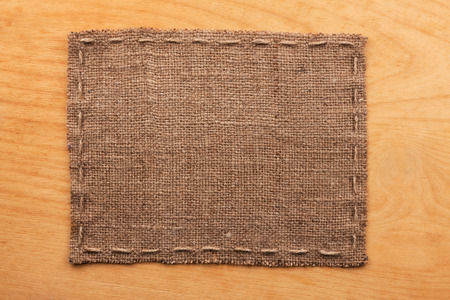 Frame of burlap, lies on a background of wood, with place for your textの写真素材